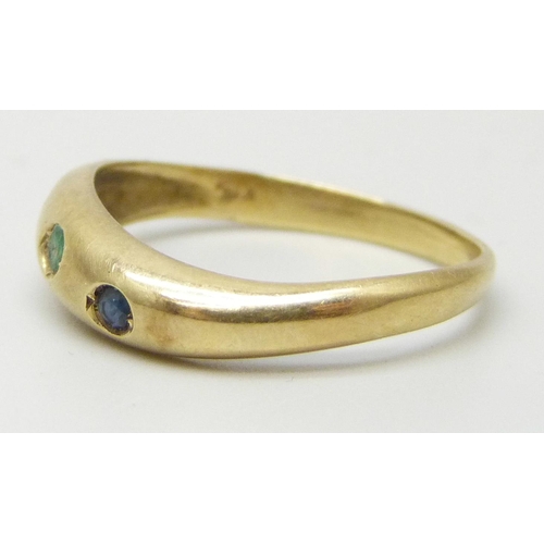 7008 - A 14ct gold three stone ring set with emerald, sapphire and ruby, 2.1g, O