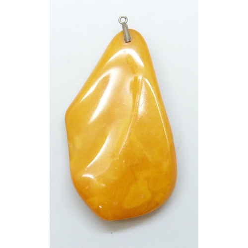 7019 - A butterscotch amber pendant, lacking bail, 6.3g, 4.6cm