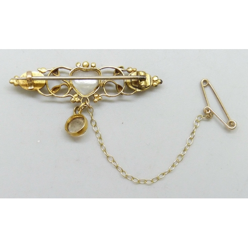 7025 - A Victorian yellow metal bar brooch set with cabochon moonstones and turquoise, the central stone in... 