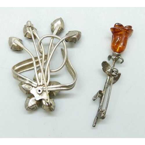 7046 - Two floral design brooches, a silver brooch set with green and red stones, 4.7cm, and a white metal ... 