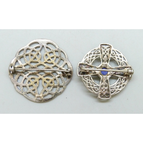 7055 - Two silver Scottish style Celtic brooches including a cross example set with a blue stone, largest 3... 