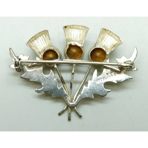 7058 - A Scottish silver thistle design brooch set with paste stones, 4.5cm