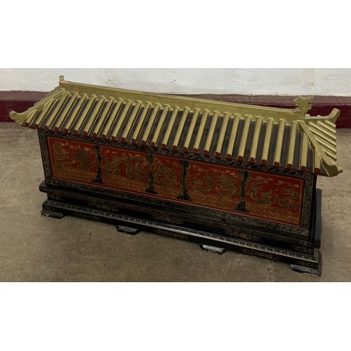 A Chinoiserie black lacquered temple shaped box