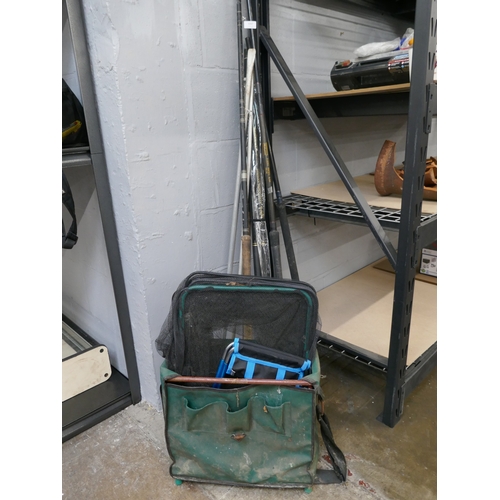 5067 - Three assorted fishing rods and a fishing bag with nets and quantity of assorted fishing reels