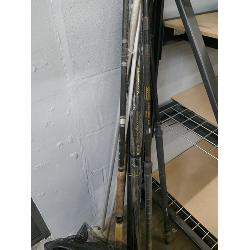 5067 - Three assorted fishing rods and a fishing bag with nets and quantity of assorted fishing reels