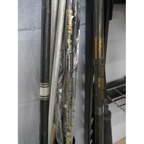 5067 - Three assorted fishing rods and a fishing bag with nets and quantity of assorted fishing reels