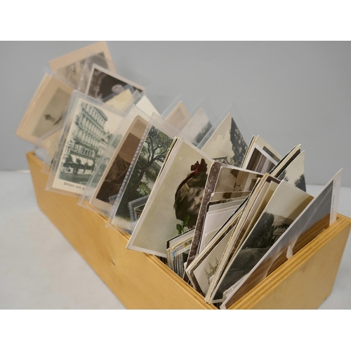 2072 - A wooden box of vintage postcards
