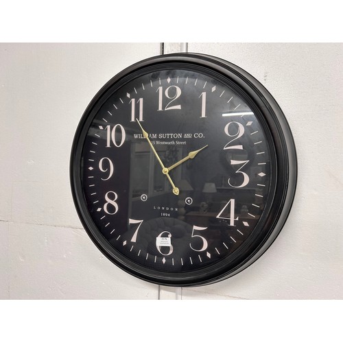 3208 - A ‘William Sutton and Co’ modern wall hanging clock
