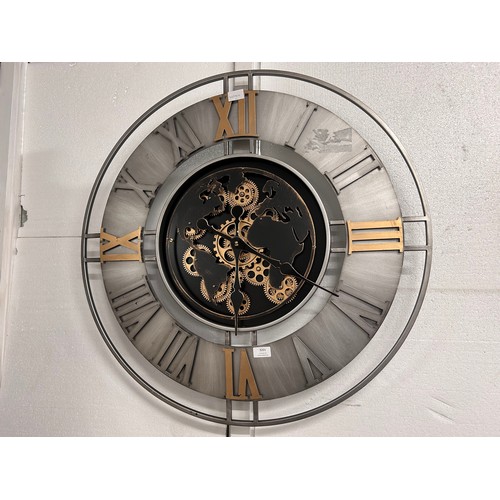 3201 - A large silver, black and gold world moving gear clock
