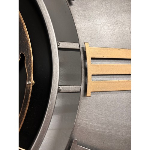 3201 - A large silver, black and gold world moving gear clock