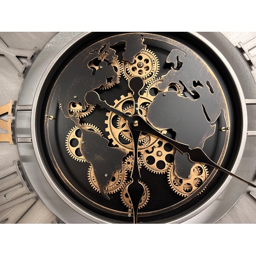 3201 - A large silver, black and gold world moving gear clock