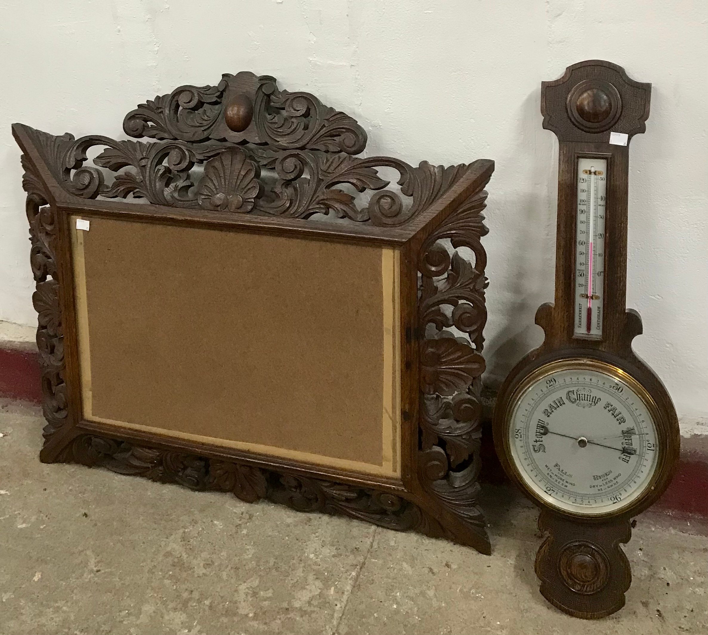 An early 20th Century carved oak barometer and picture frame
