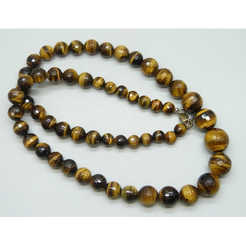 7168 - A faceted tiger’s eye gemstone bead necklace with a silver clasp, 50cm, 94g