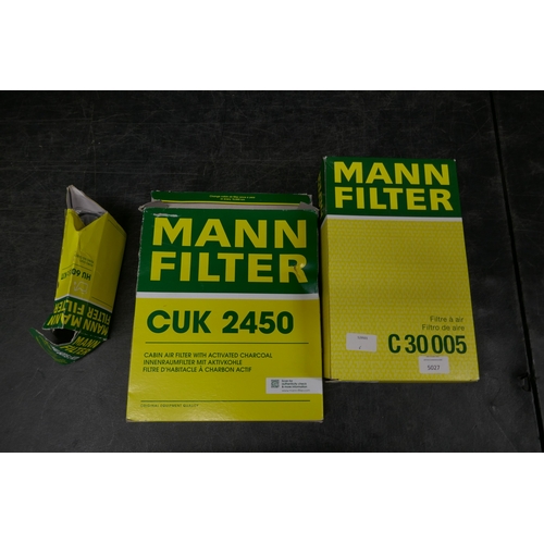 5099 - A selection of Mann filter products including a C30005 air filter, a CUK2450 cabin air filter with a... 