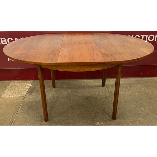 26 - A Danish teak circular extending dining table