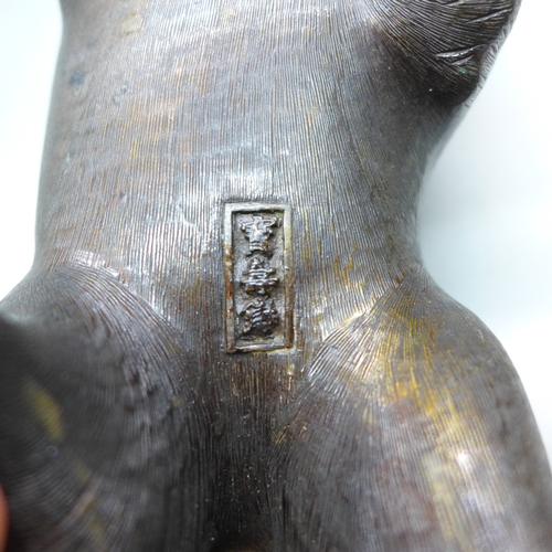 2093 - Two c1900 Japanese bronze figures, a seated fox and a Japanese raccoon dog, signed, fox 14.5cm