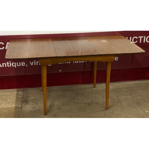 47 - A Beautility afromosia rectangular extending dining table and four chairs