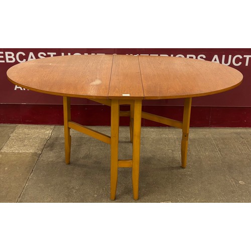 23 - A teak drop-leaf table