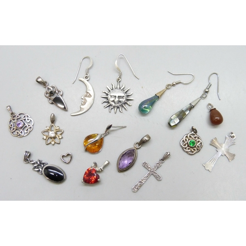 7242 - A collection of silver and white metal pendants and single earrings, some plated