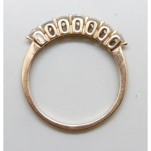 7243 - A 10k gold ring set with seven white stones, 2.2g, S