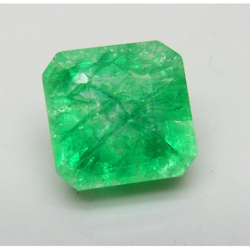 7245 - An unmounted 6.3ct emerald, with certificate