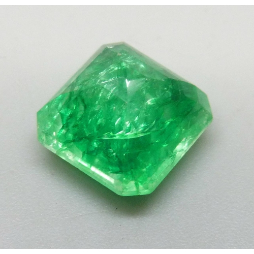 7245 - An unmounted 6.3ct emerald, with certificate
