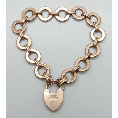 7257 - A 9ct gold circle link bracelet with a 9ct gold padlock clasp, 18.9g, 1.3cm wide links