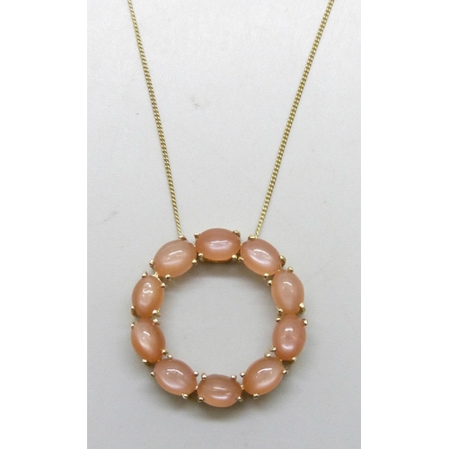 7281A - A Mitiyagoda peach moonstone Circle of Life sterling silver pendant on a silver gilt chain, 2.8cm pe... 
