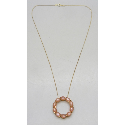 7281A - A Mitiyagoda peach moonstone Circle of Life sterling silver pendant on a silver gilt chain, 2.8cm pe... 