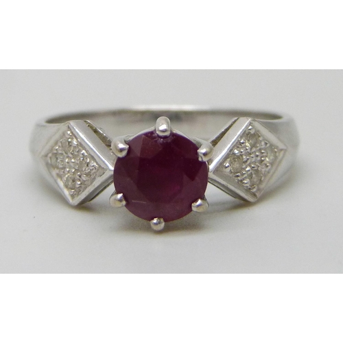 7293 - A white metal and ruby ring set with diamond shoulders, marked 750, 3.4g, N