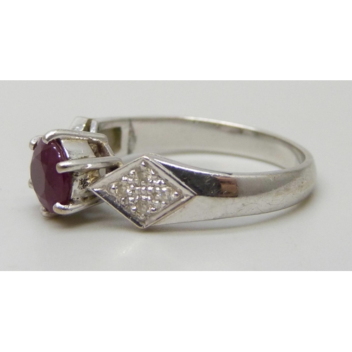 7293 - A white metal and ruby ring set with diamond shoulders, marked 750, 3.4g, N