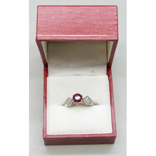 7293 - A white metal and ruby ring set with diamond shoulders, marked 750, 3.4g, N