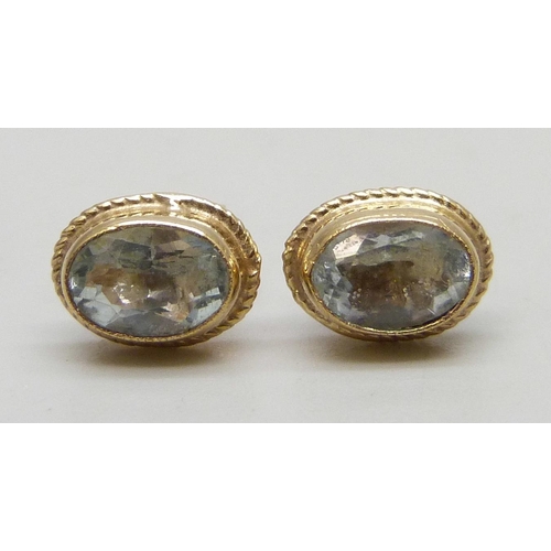 7294 - A pair of 9ct gold blue stone earrings, possibly aquamarine, with unmatched butterflies, 0.8g
