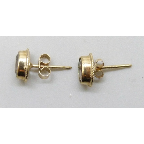 7294 - A pair of 9ct gold blue stone earrings, possibly aquamarine, with unmatched butterflies, 0.8g