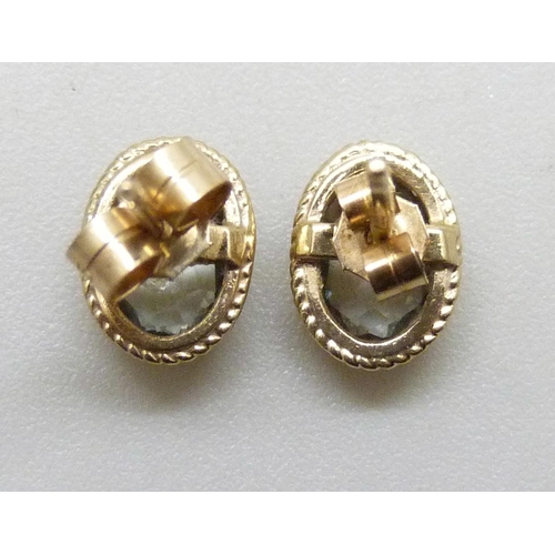 7294 - A pair of 9ct gold blue stone earrings, possibly aquamarine, with unmatched butterflies, 0.8g