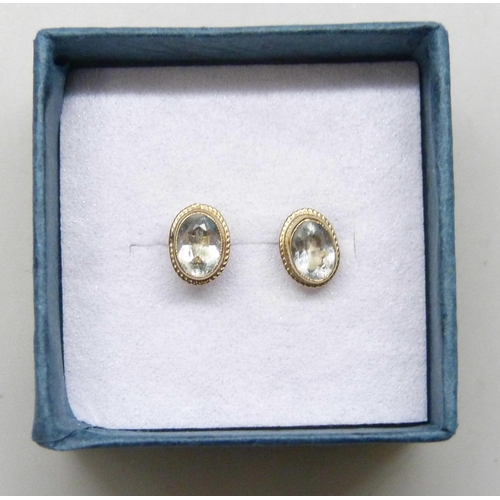 7294 - A pair of 9ct gold blue stone earrings, possibly aquamarine, with unmatched butterflies, 0.8g
