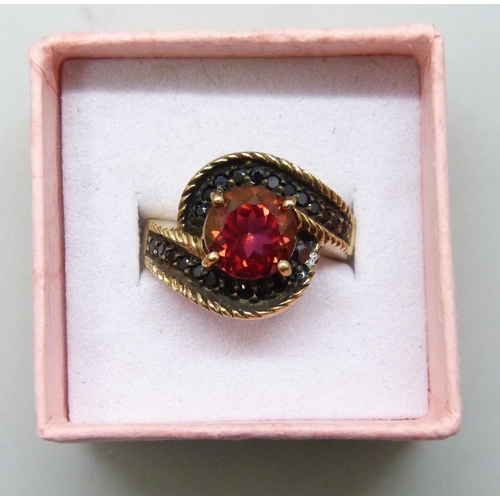 7296 - A silver gilt red and black stone ring, J