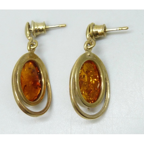 7300 - A pair of silver gilt cabochon Baltic amber earrings, plated backings, 3.3cm