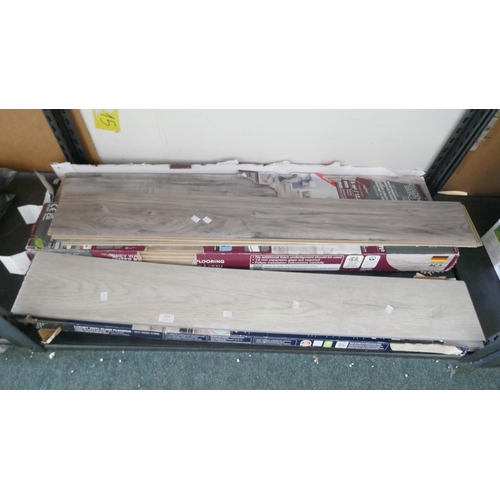 6076 - Quantity of grey walnut laminate flooring and Alabaster vinyl flooring  (371-39,40,436) *This lot is... 