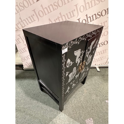 3010 - A black and grey butterfly patterned two door cabinet