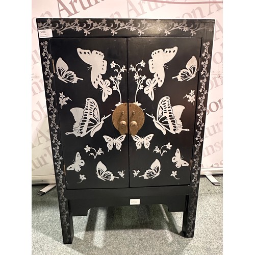 3010 - A black and grey butterfly patterned two door cabinet