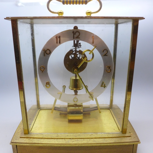 2018 - A Kindo Electronic brass and glass mantel clock, one foot missing