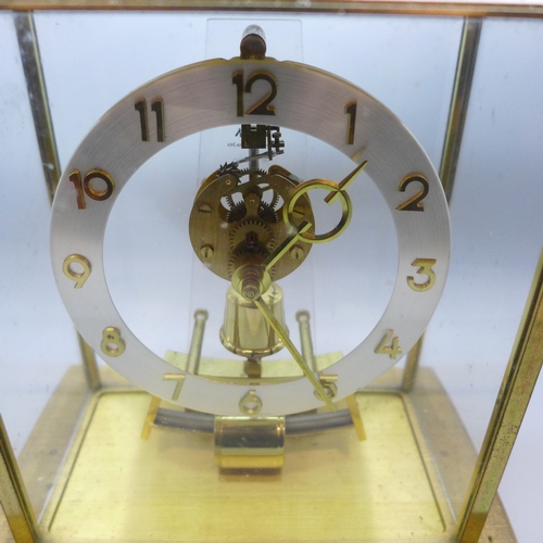 2018 - A Kindo Electronic brass and glass mantel clock, one foot missing