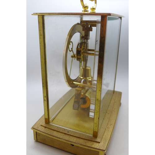 2018 - A Kindo Electronic brass and glass mantel clock, one foot missing