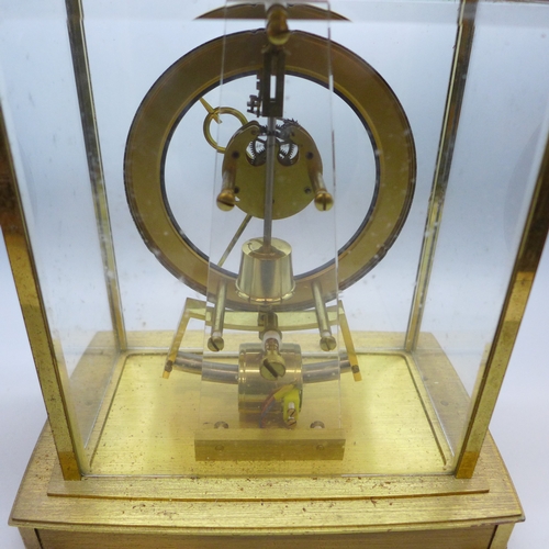 2018 - A Kindo Electronic brass and glass mantel clock, one foot missing