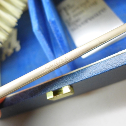 7337 - A silver mounted three piece brush/comb set, boxed