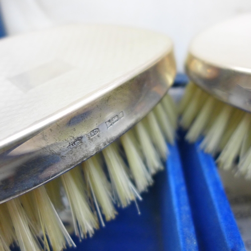 7337 - A silver mounted three piece brush/comb set, boxed