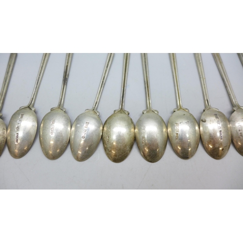 7340 - A set of twenty three silver golf spoons, mainly by Walker & Hall, different years, 270g