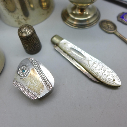 7343 - Nine pieces of silver including a Victorian jug, a pot with embossed figures to lid, an egg cup, a s... 