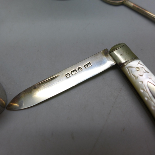 7343 - Nine pieces of silver including a Victorian jug, a pot with embossed figures to lid, an egg cup, a s... 